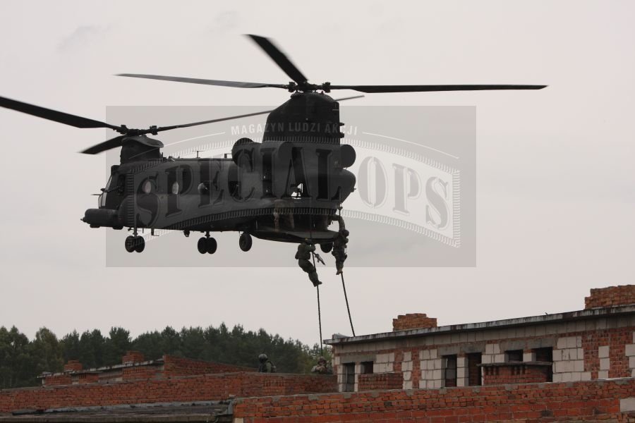 Desant komandosów ze śmigłowca Chinook, metodą szybkiej liny, na dach szturmowanego budynku.