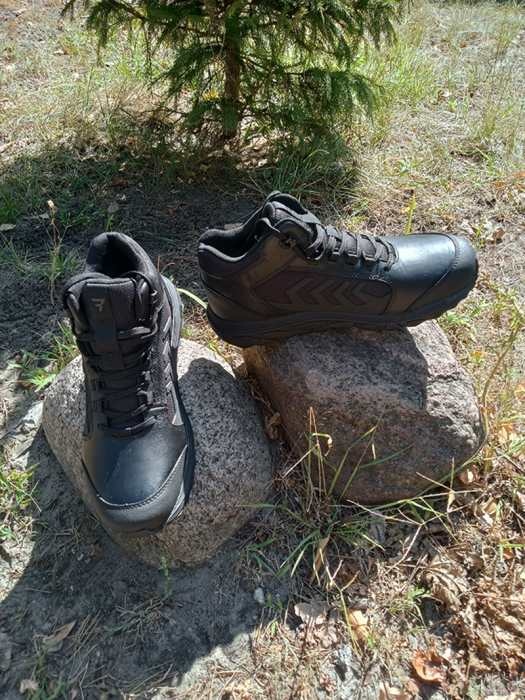 czarne buty taktyczne w lesie na kamieniach w słonecznym świetle